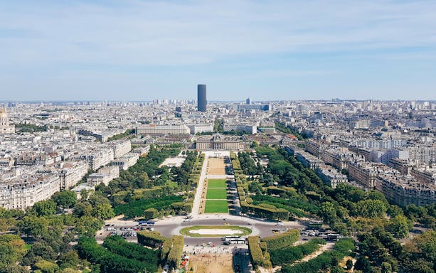 View of Paris skyline and Champ de Mars from Eiffel Tower observation deck.