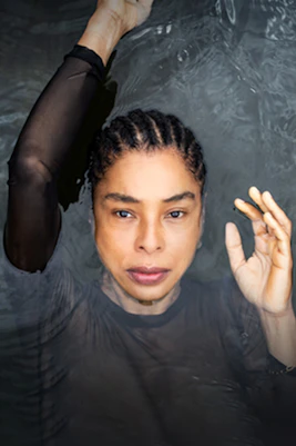 Actor in water with text promoting the play Medea by Euripides.