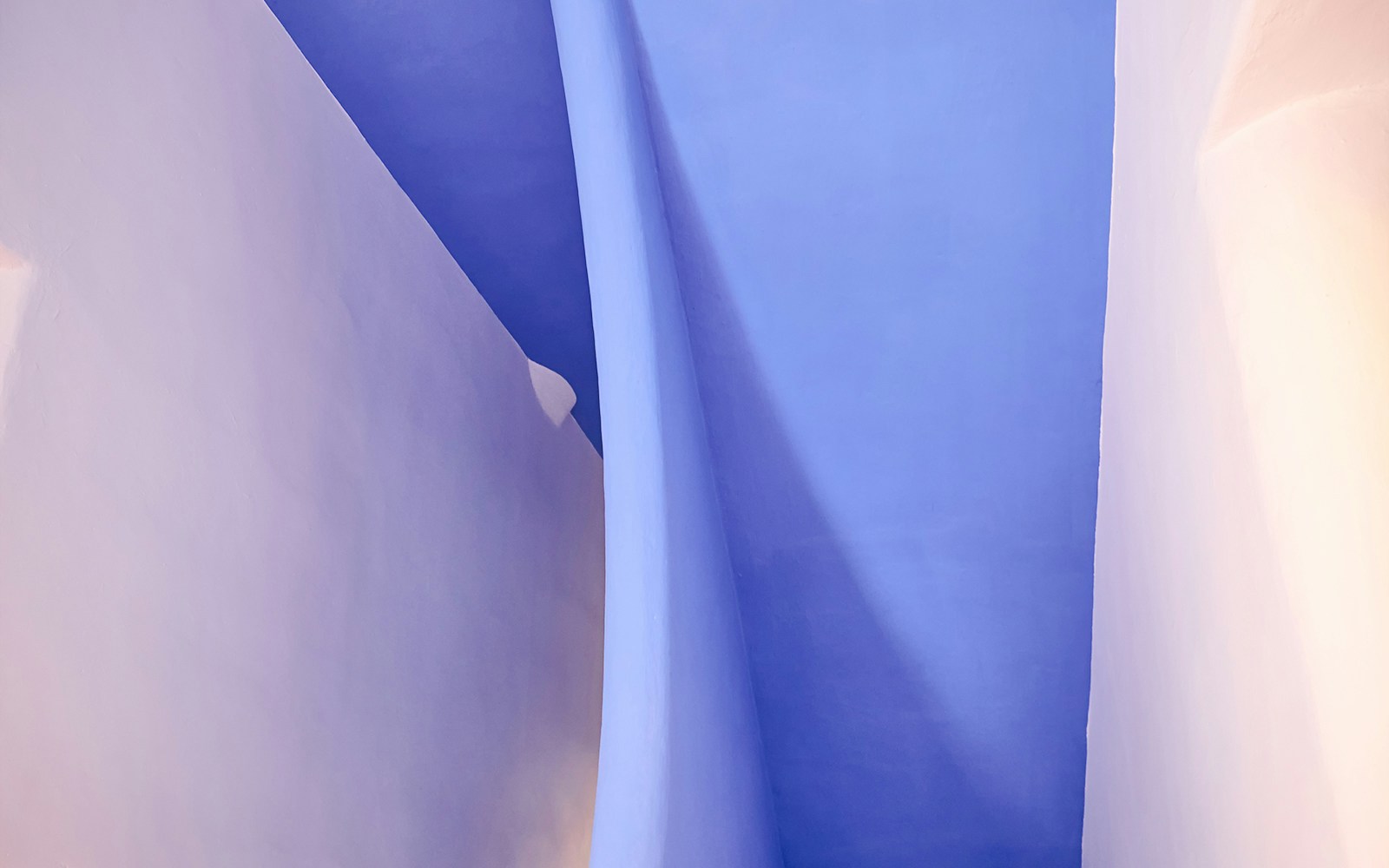 Curved blue and white walls inside Casa del Guarda, Park Güell, Barcelona.