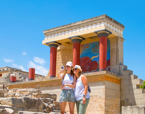 Visitors touring ancient ruins at Knossos Palace, Crete, Greece.