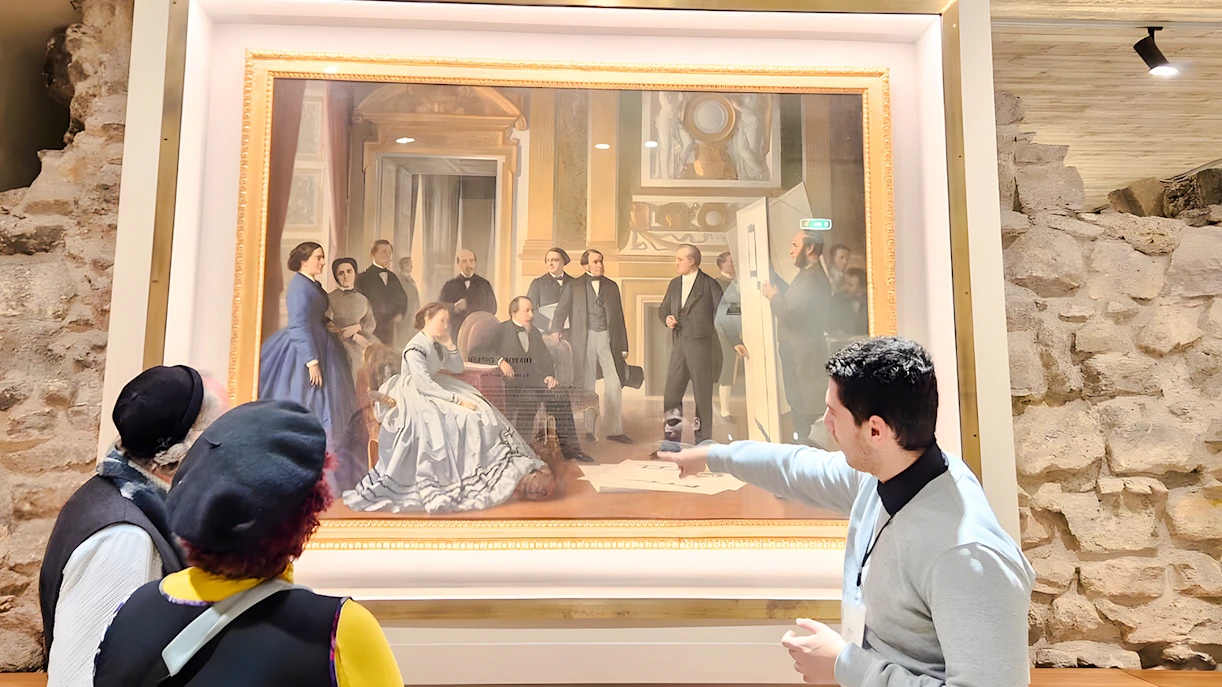 Visitors viewing a painting inside the Louvre Museum, Paris, France.