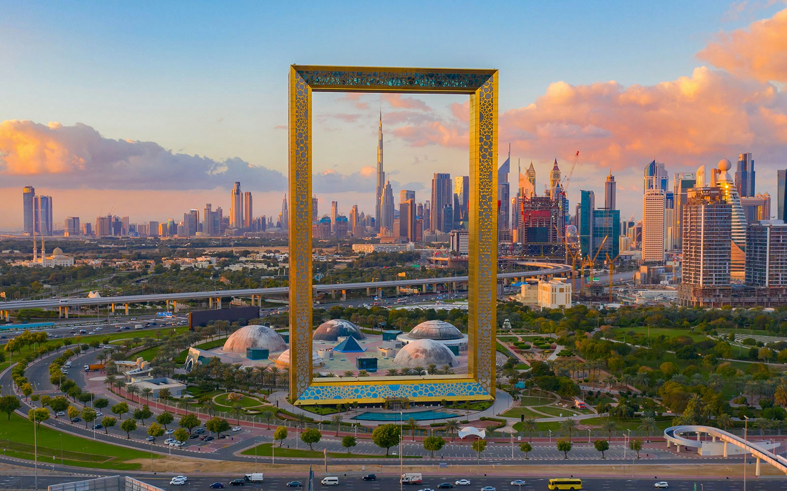 Aerial view of Dubai Frame with city skyline in the background.