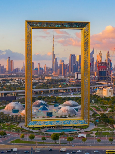 Aerial view of Dubai Frame with city skyline in the background.