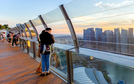 Couple enjoying city view from Marina Bay Sands SkyPark Observation Deck, Singapore.