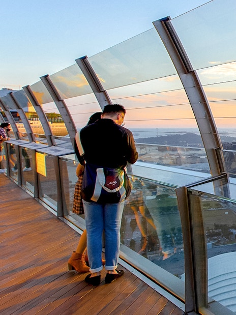 Couple enjoying city view from Marina Bay Sands SkyPark Observation Deck, Singapore.