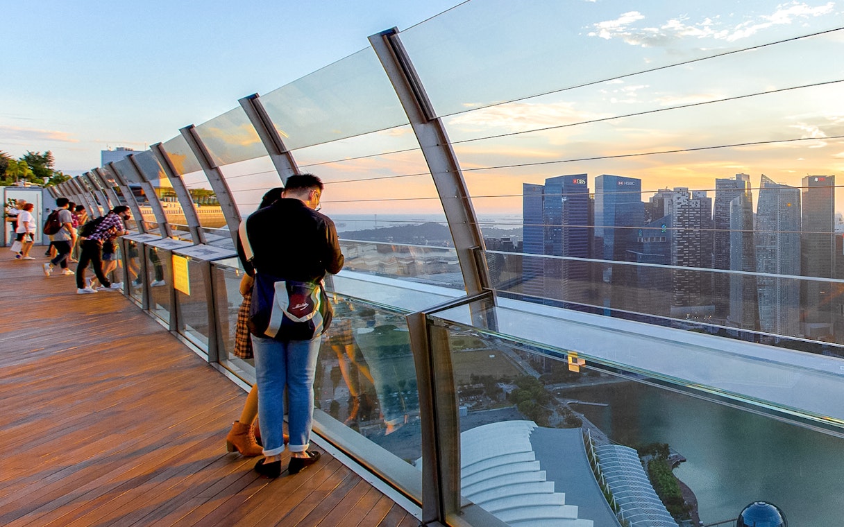 Couple enjoying city view from Marina Bay Sands SkyPark Observation Deck, Singapore.