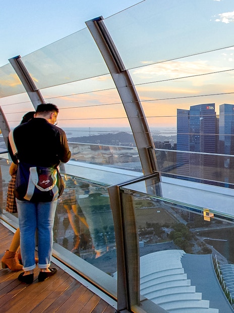 Couple enjoying city view from Marina Bay Sands SkyPark Observation Deck, Singapore.