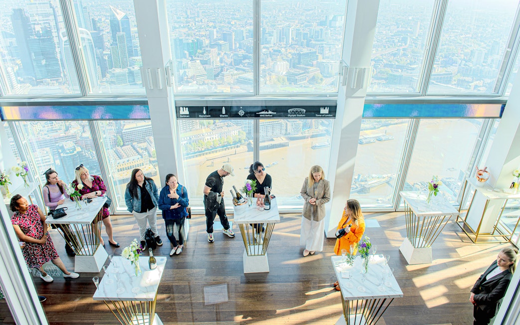 Guests enjoying champagne with a view of London from The Shard.