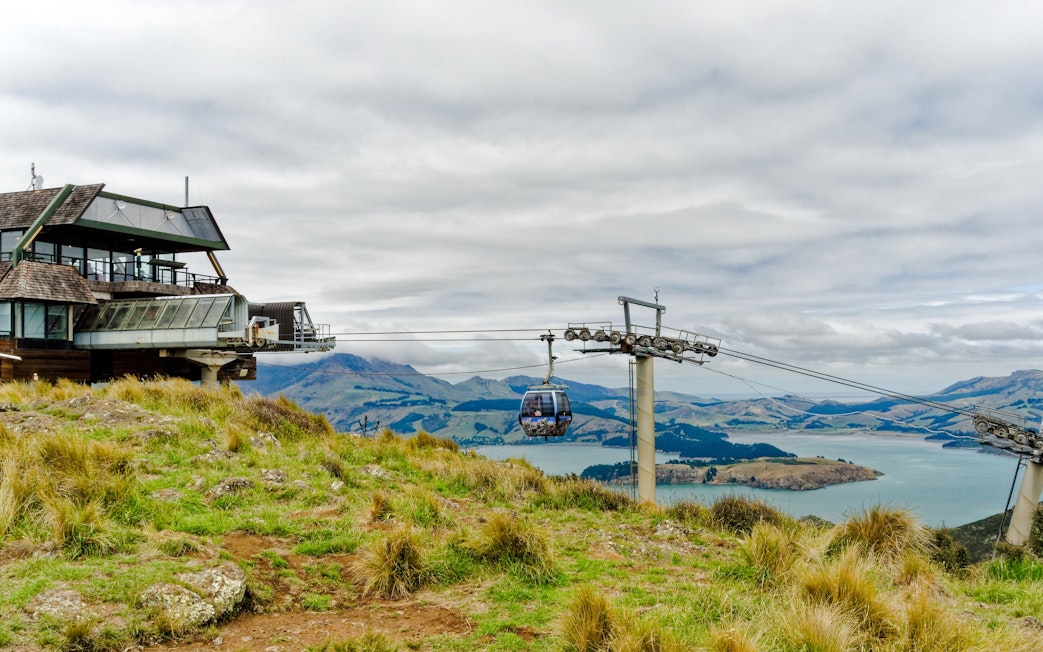 Gondola ride over Port Hills with view of Christchurch landscape and water.