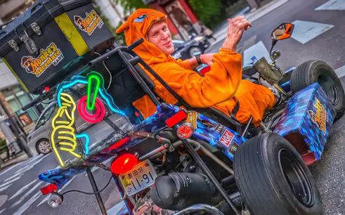 Go-kart rider in costume on street during Asakusa, Skytree & Akihabara go-karting experience.