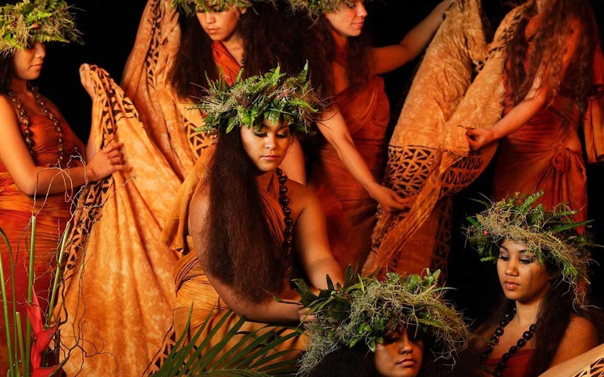 Dancers in traditional attire at Luau Kalamaku cultural show, Hawaii.