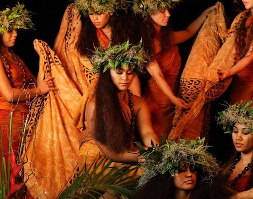 Dancers in traditional attire at Luau Kalamaku cultural show, Hawaii.