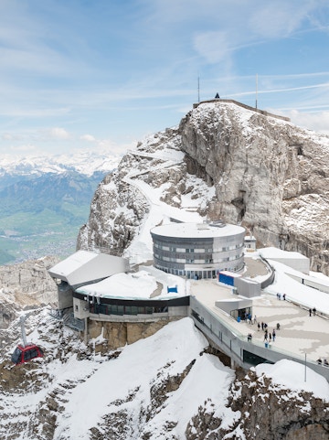 Mount Pilatus summit with snow-covered buildings and cable car station, Switzerland.
