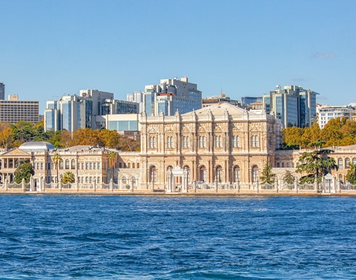 Dolmabahce Palace exterior with ornate architecture and Bosphorus view in Istanbul, Turkey.