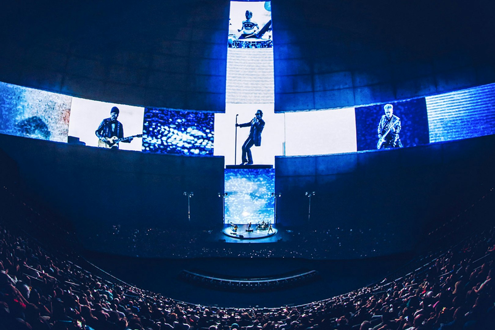 Audience watching immersive concert film at Sphere Las Vegas with band performing on stage.