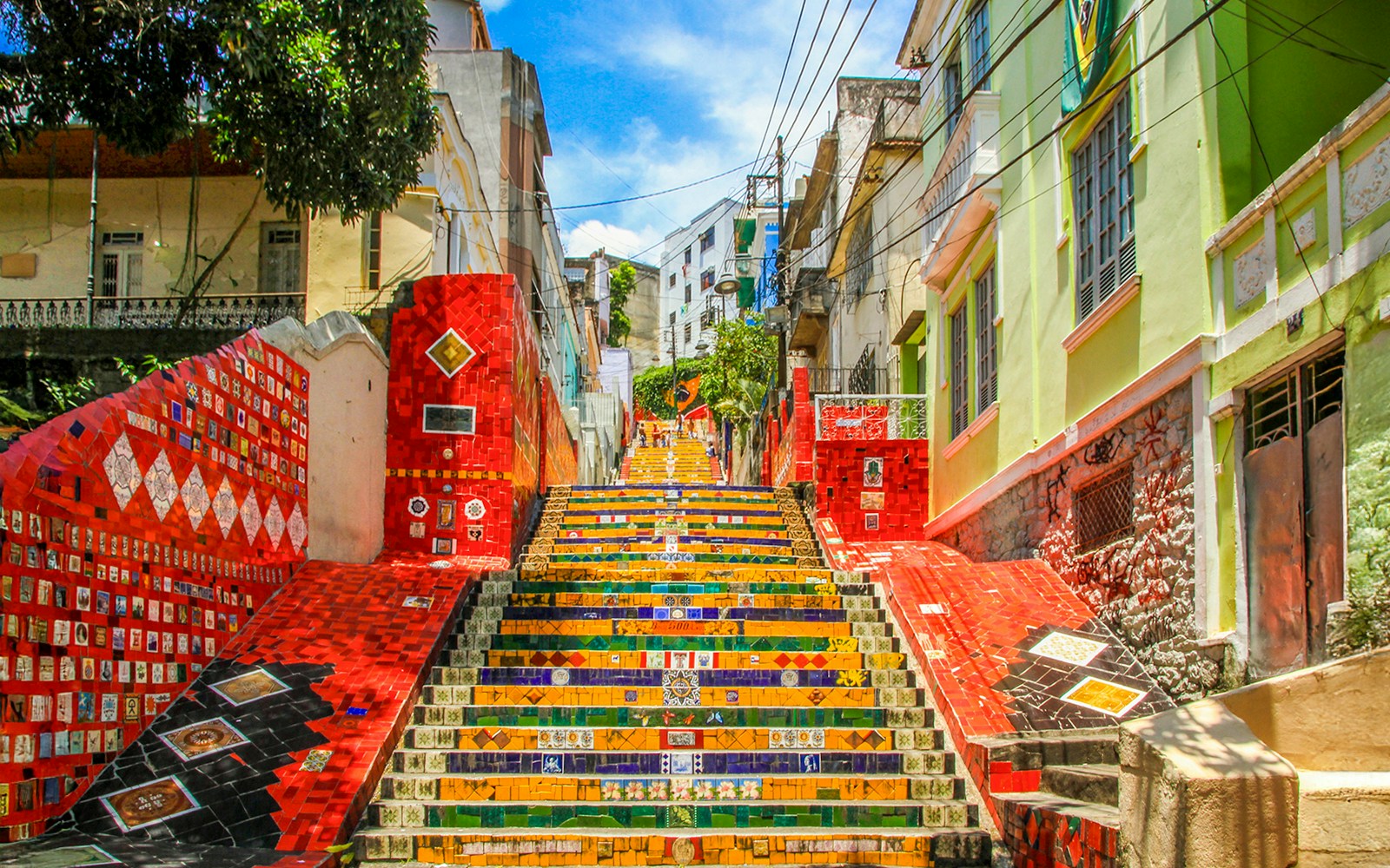 Escadaria Selarón in Rio de Janeiro, vibrant mosaic-tiled steps ascending between colorful buildings.