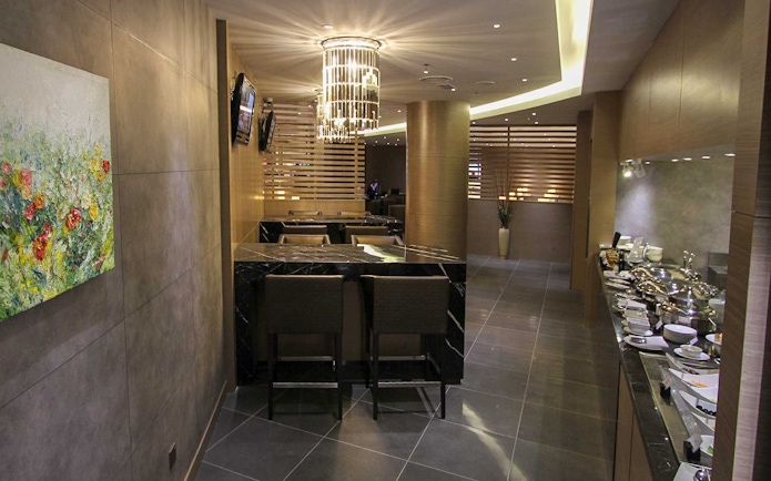 Plaza Premium Lounge interior with seating and buffet area.