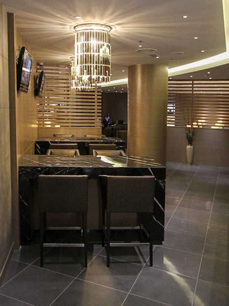 Plaza Premium Lounge interior with seating and buffet area.