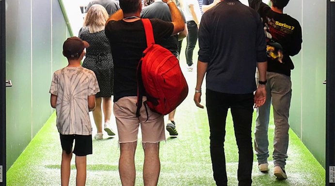Visitors walking through the tunnel at Tottenham Hotspur Stadium.