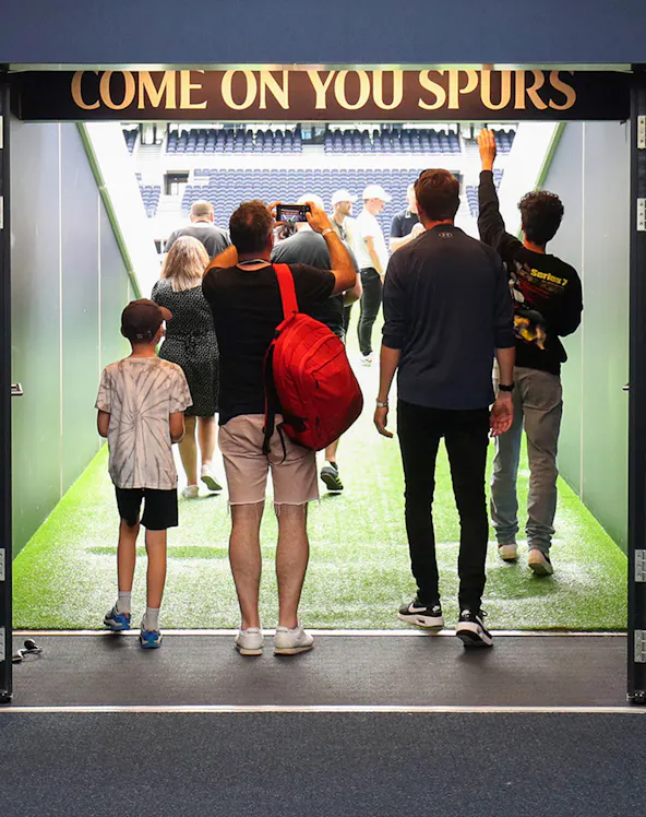 Visitors walking through the tunnel at Tottenham Hotspur Stadium.