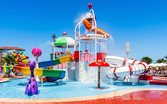 Colorful water slides and splash area at Agadir Aqua Park, Morocco.