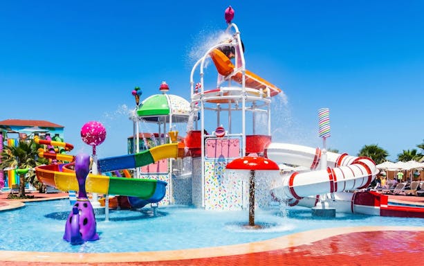 Colorful water slides and splash area at Agadir Aqua Park, Morocco.