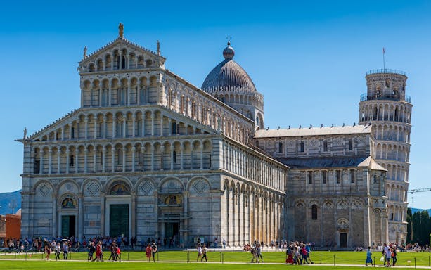 Cathedral and Leaning Tower at Piazza dei Miracoli, Pisa, with tourists exploring.