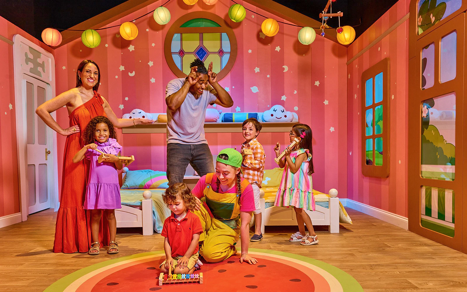 Children playing in a colorful room at CBeebies Rainbow Adventure.