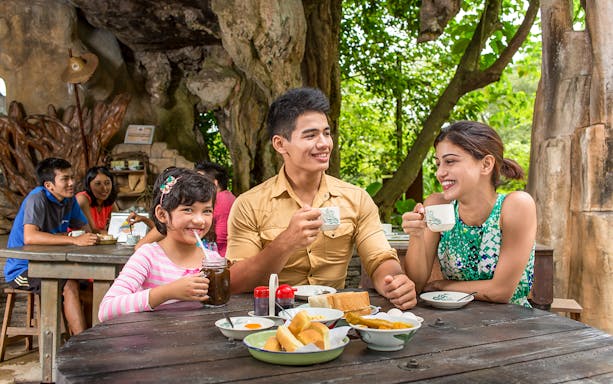 Family enjoying breakfast at Sunway Lost World of Tambun, Malaysia.