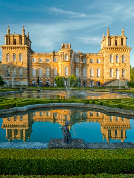 Blenheim Palace exterior with gardens and reflecting pool in Oxfordshire, England.