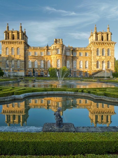 Blenheim Palace exterior with gardens and reflecting pool in Oxfordshire, England.