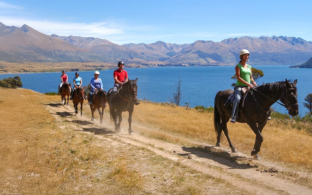 Horse trekking near Lake Wakatipu with mountain views, Queenstown.