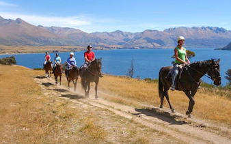 Horse trekking near Lake Wakatipu with mountain views, Queenstown.