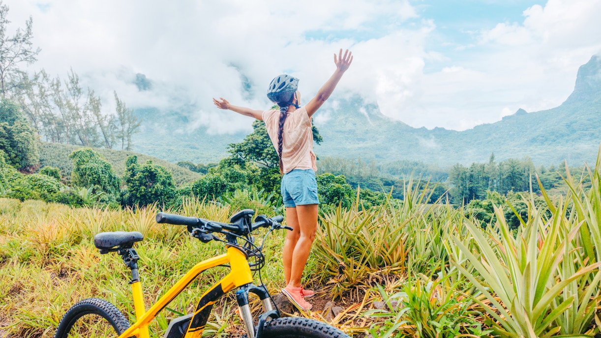 woman standing near her e bike in mountains