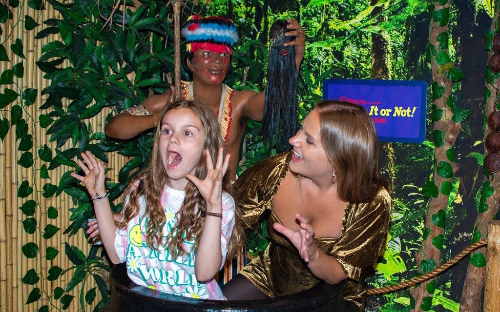 Visitors posing in a jungle-themed exhibit at Ripley's Believe It or Not!