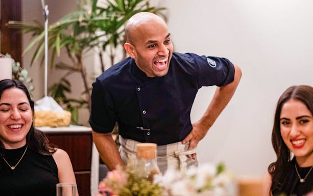 Chef engaging with guests at Chef Kuv's Secret Supper, an underground dining experience.