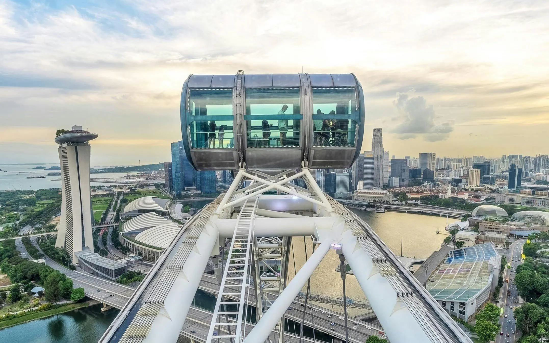 Singapore Flyer capsule overlooking Marina Bay and city skyline.