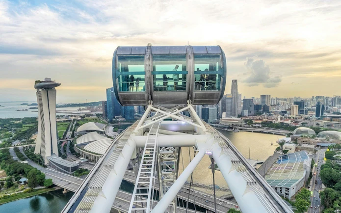 Singapore Flyer capsule overlooking Marina Bay and city skyline.
