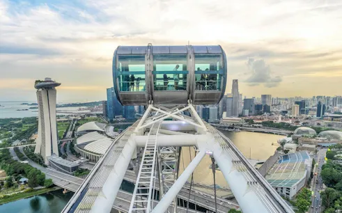 Singapore Flyer capsule overlooking Marina Bay and city skyline.