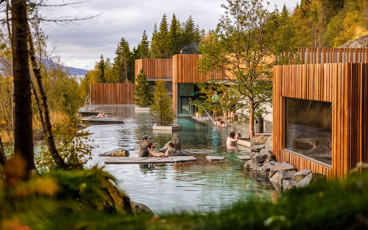 Forest Lagoon geothermal spa entrance with visitors in Vaðlaskógur forest, near Akureyri, North Iceland.