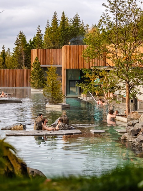 Forest Lagoon geothermal spa entrance with visitors in Vaðlaskógur forest, near Akureyri, North Iceland.