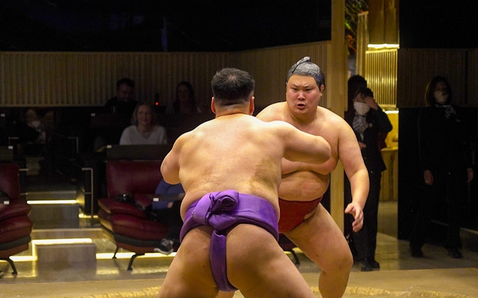 Sumo wrestlers competing at Asakusa Sumo Club, Tokyo.