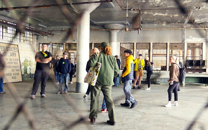Ranger speaking to visitors during a Behind The Scenes Tour on Alcatraz Island.