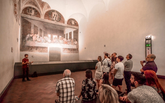 Tour group viewing The Last Supper painting in Milan's Santa Maria delle Grazie.