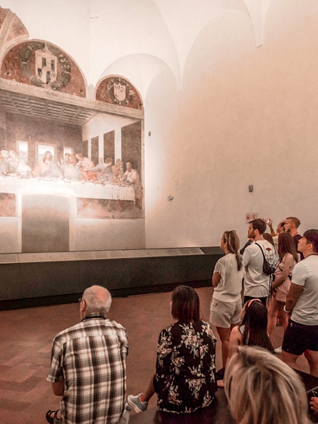 Tour group viewing The Last Supper painting in Milan's Santa Maria delle Grazie.