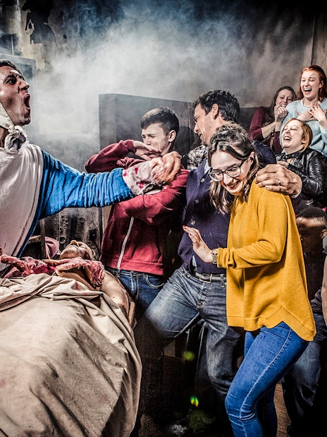 Guests reacting to a live performance at the Amsterdam Dungeon.