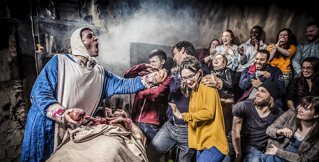 Guests reacting to a live performance at the Amsterdam Dungeon.