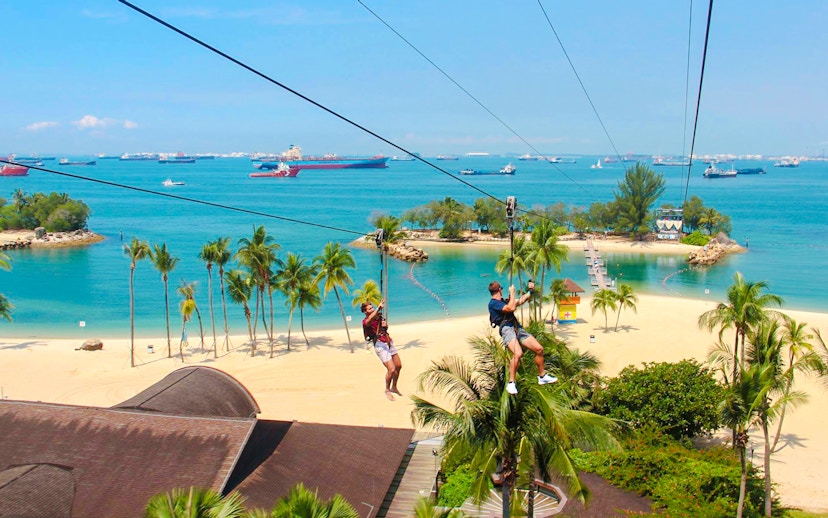 Ziplining over Sentosa Beach at Mega Adventure Park, Singapore.