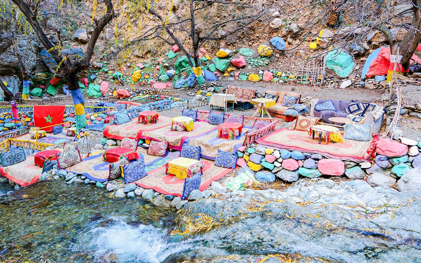 Colorful seating area by a stream in Setti Fadma, Ourika Valley, Morocco.