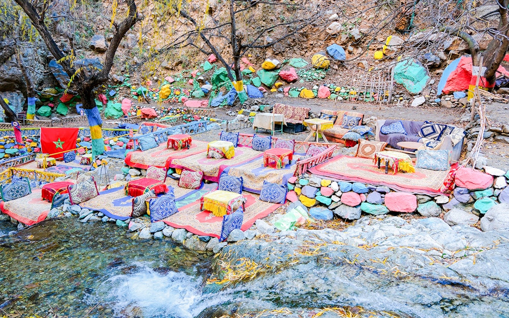Colorful seating area by a stream in Setti Fadma, Ourika Valley, Morocco.